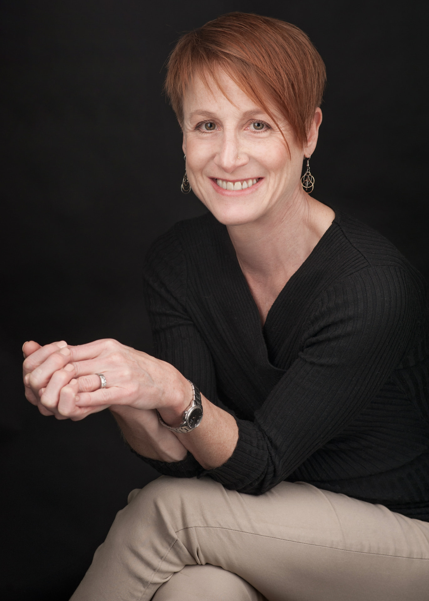Sharyn Galindo, National Board-Certified Health and Wellness Coach, smiling warmly in a professional portrait